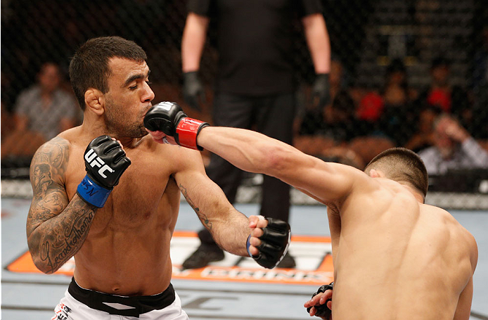 LAS VEGAS, NV - JULY 06: (R-L) Jumabieke Tuerxun punches Leandro Issa in their bantamweight fight during the Ultimate Fighter Finale inside the Mandalay Bay Events Center on July 6, 2014 in Las Vegas, Nevada. (Photo by Josh Hedges/Zuffa LLC/Zuffa LLC vi