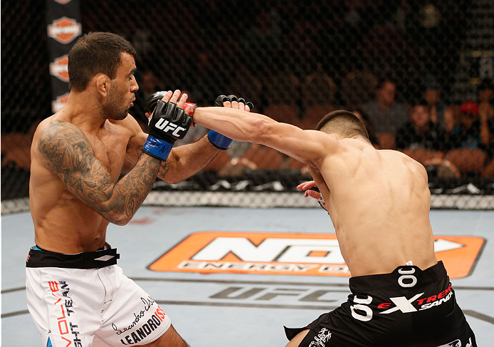 LAS VEGAS, NV - JULY 06: (R-L) Jumabieke Tuerxun punches Leandro Issa in his bantamweight fight during the Ultimate Fighter Finale inside the Mandalay Bay Events Center on July 6, 2014 in Las Vegas, Nevada. (Photo by Josh Hedges/Zuffa LLC/Zuffa LLC via