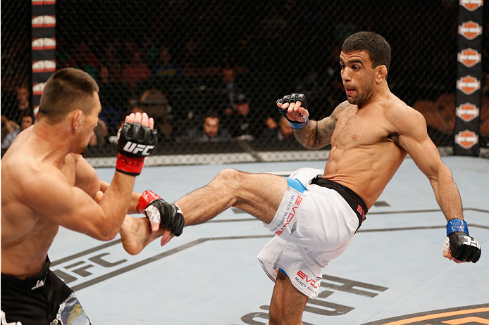 LAS VEGAS, NV - JULY 06:  (R-L) Leandro Issa kicks Jumabieke Tuerxun in their bantamweight fight during the Ultimate Fighter Finale inside the Mandalay Bay Events Center on July 6, 2014 in Las Vegas, Nevada.  (Photo by Josh Hedges/Zuffa LLC/Zuffa LLC via 