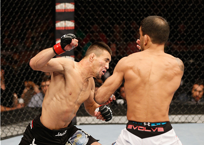 LAS VEGAS, NV - JULY 06:  (L-R) Jumabieke Tuerxun punches Leandro Issa in their bantamweight fight during the Ultimate Fighter Finale inside the Mandalay Bay Events Center on July 6, 2014 in Las Vegas, Nevada.  (Photo by Josh Hedges/Zuffa LLC/Zuffa LLC vi