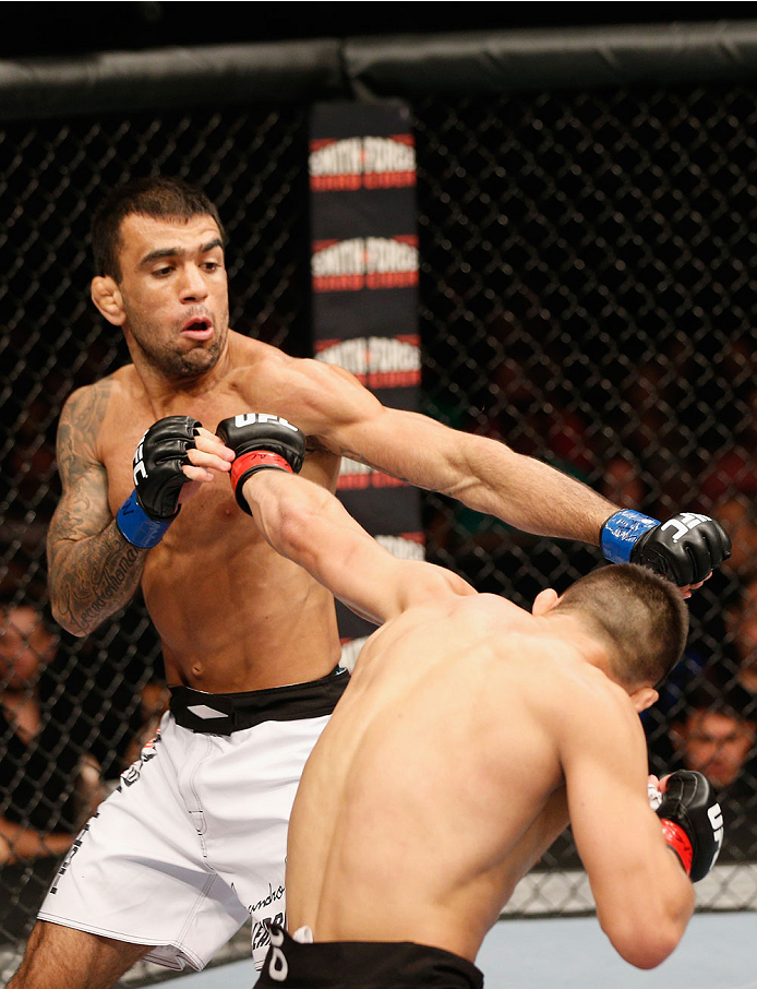 LAS VEGAS, NV - JULY 06: (R-L) Jumabieke Tuerxun and Leandro Issa exchange punches in their bantamweight fight during the Ultimate Fighter Finale inside the Mandalay Bay Events Center on July 6, 2014 in Las Vegas, Nevada. (Photo by Josh Hedges/Zuffa LLC