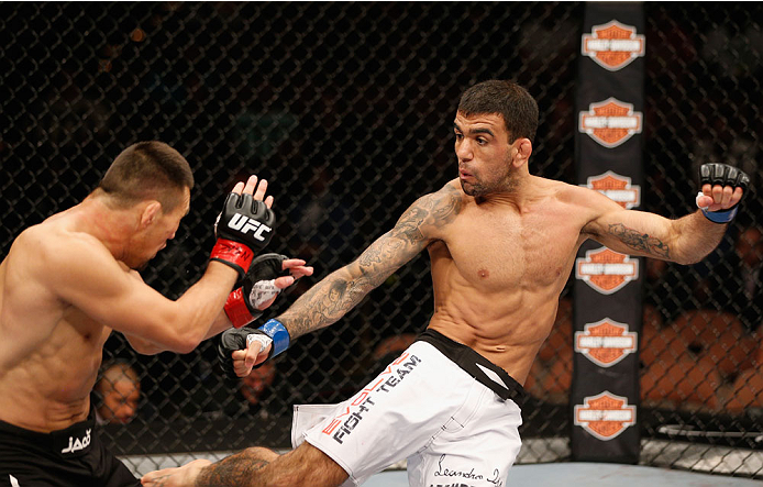 LAS VEGAS, NV - JULY 06: (R-L) Leandro Issa kicks Jumabieke Tuerxun in their bantamweight fight during the Ultimate Fighter Finale inside the Mandalay Bay Events Center on July 6, 2014 in Las Vegas, Nevada. (Photo by Josh Hedges/Zuffa LLC/Zuffa LLC via