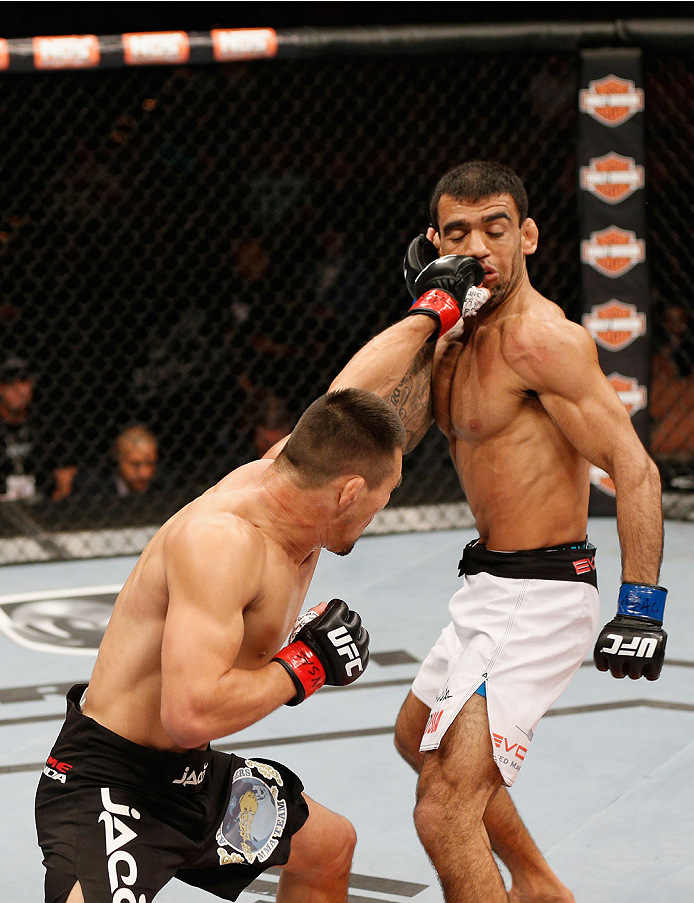 LAS VEGAS, NV - JULY 06:  (L-R) Jumabieke Tuerxun punches Leandro Issa in their bantamweight fight during the Ultimate Fighter Finale inside the Mandalay Bay Events Center on July 6, 2014 in Las Vegas, Nevada.  (Photo by Josh Hedges/Zuffa LLC/Zuffa LLC vi