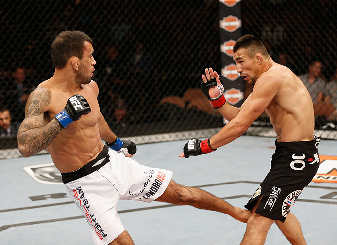 LAS VEGAS, NV - JULY 06: (L-R) Leandro Issa kicks Jumabieke Tuerxun in their bantamweight fight during the Ultimate Fighter Finale inside the Mandalay Bay Events Center on July 6, 2014 in Las Vegas, Nevada. (Photo by Josh Hedges/Zuffa LLC/Zuffa LLC via