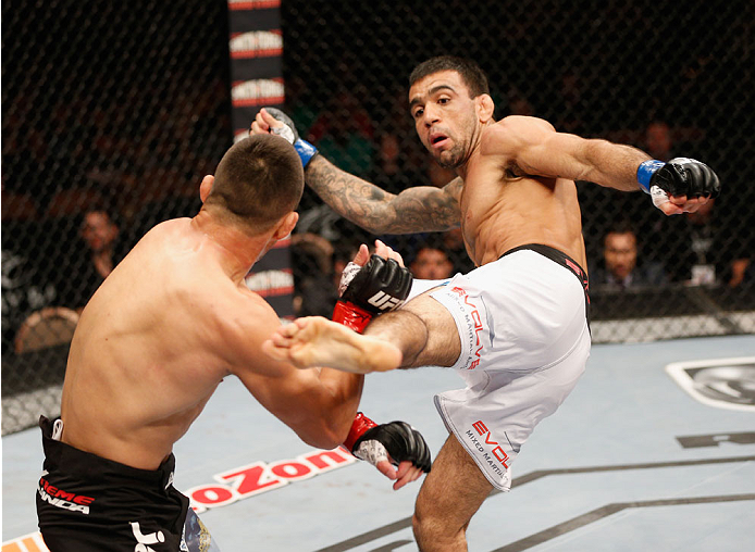 LAS VEGAS, NV - JULY 06: (R-L) Leandro Issa kicks Jumabieke Tuerxun in their bantamweight fight during the Ultimate Fighter Finale inside the Mandalay Bay Events Center on July 6, 2014 in Las Vegas, Nevada. (Photo by Josh Hedges/Zuffa LLC/Zuffa LLC via