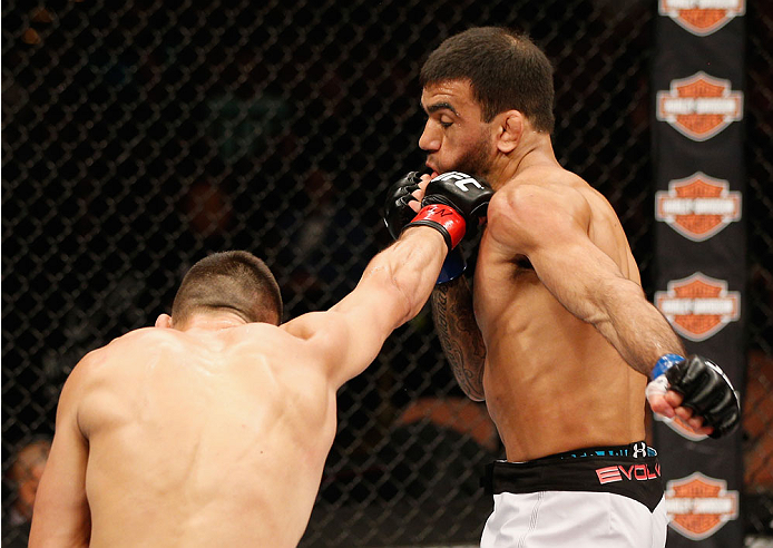 LAS VEGAS, NV - JULY 06:  (L-R) Jumabieke Tuerxun punches Leandro Issa in their bantamweight fight during the Ultimate Fighter Finale inside the Mandalay Bay Events Center on July 6, 2014 in Las Vegas, Nevada.  (Photo by Josh Hedges/Zuffa LLC/Zuffa LLC vi