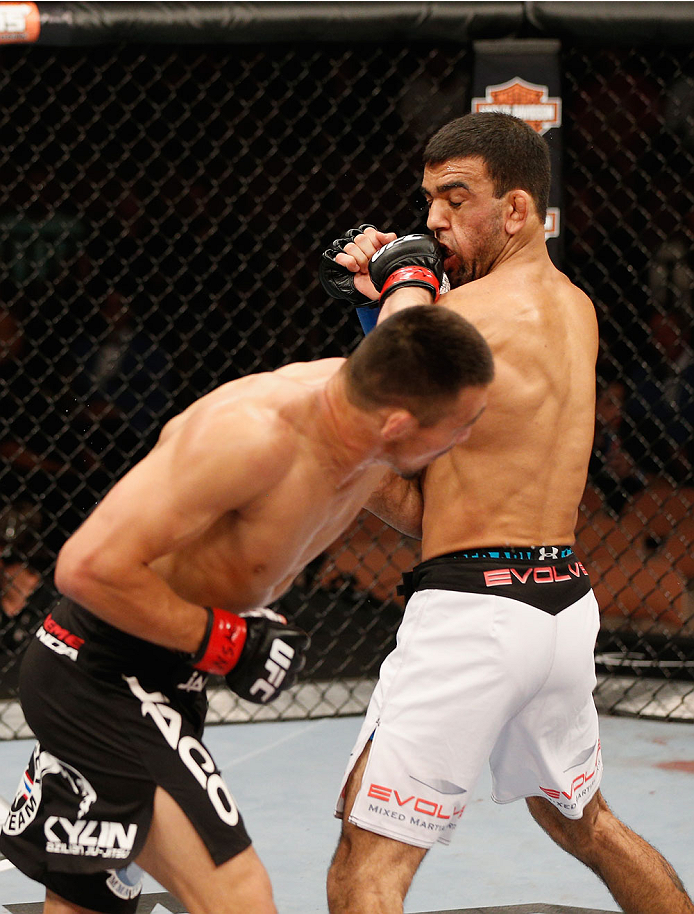 LAS VEGAS, NV - JULY 06:  (L-R) Jumabieke Tuerxun punches Leandro Issa in their bantamweight fight during the Ultimate Fighter Finale inside the Mandalay Bay Events Center on July 6, 2014 in Las Vegas, Nevada.  (Photo by Josh Hedges/Zuffa LLC/Zuffa LLC vi