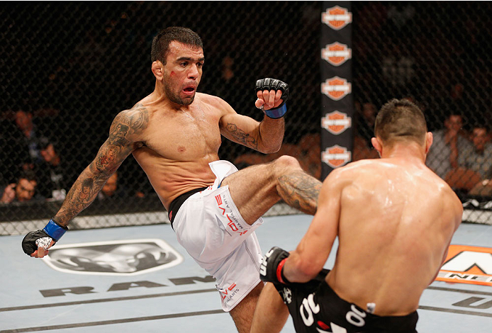 LAS VEGAS, NV - JULY 06: (L-R) Leandro Issa kicks Jumabieke Tuerxun in their bantamweight fight during the Ultimate Fighter Finale inside the Mandalay Bay Events Center on July 6, 2014 in Las Vegas, Nevada. (Photo by Josh Hedges/Zuffa LLC/Zuffa LLC via