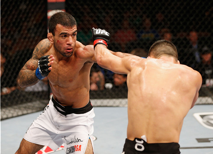 LAS VEGAS, NV - JULY 06:  (L-R) Leandro Issa punches Jumabieke Tuerxun in their bantamweight fight during the Ultimate Fighter Finale inside the Mandalay Bay Events Center on July 6, 2014 in Las Vegas, Nevada.  (Photo by Josh Hedges/Zuffa LLC/Zuffa LLC vi