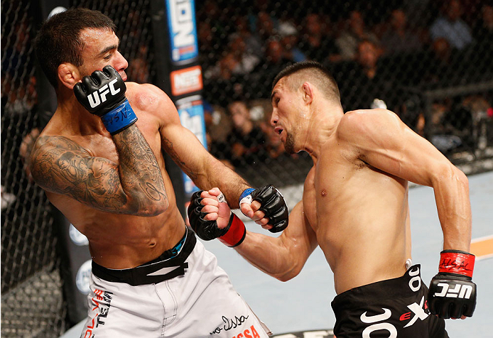 LAS VEGAS, NV - JULY 06: (R-L) Jumabieke Tuerxun punches Leandro Issa in their bantamweight fight during the Ultimate Fighter Finale inside the Mandalay Bay Events Center on July 6, 2014 in Las Vegas, Nevada. (Photo by Josh Hedges/Zuffa LLC/Zuffa LLC vi