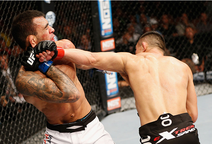 LAS VEGAS, NV - JULY 06: (R-L) Jumabieke Tuerxun punches Leandro Issa in their bantamweight fight during the Ultimate Fighter Finale inside the Mandalay Bay Events Center on July 6, 2014 in Las Vegas, Nevada. (Photo by Josh Hedges/Zuffa LLC/Zuffa LLC vi