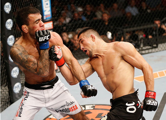 LAS VEGAS, NV - JULY 06: (R-L) Jumabieke Tuerxun punches Leandro Issa in their bantamweight fight during the Ultimate Fighter Finale inside the Mandalay Bay Events Center on July 6, 2014 in Las Vegas, Nevada. (Photo by Josh Hedges/Zuffa LLC/Zuffa LLC vi