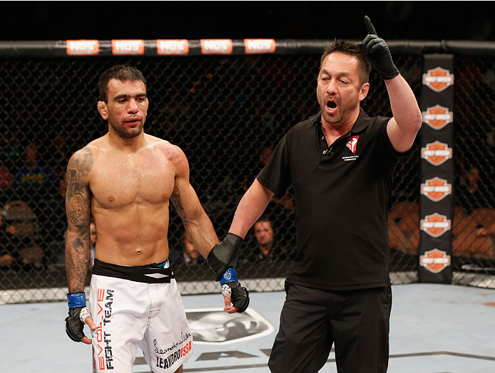 LAS VEGAS, NV - JULY 06:  (L) Leandro Issa is deducted a point for using the fence in his bantamweight fight with Jumabieke Tuerxun during the Ultimate Fighter Finale inside the Mandalay Bay Events Center on July 6, 2014 in Las Vegas, Nevada.  (Photo by J