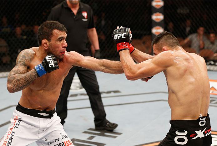 LAS VEGAS, NV - JULY 06: (L-R) Leandro Issa punches Jumabieke Tuerxun in their bantamweight fight during the Ultimate Fighter Finale inside the Mandalay Bay Events Center on July 6, 2014 in Las Vegas, Nevada. (Photo by Josh Hedges/Zuffa LLC/Zuffa LLC vi