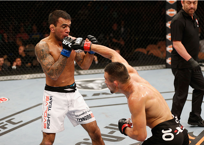 LAS VEGAS, NV - JULY 06: (R-L) Jumabieke Tuerxun punches Leandro Issa in their bantamweight fight during the Ultimate Fighter Finale inside the Mandalay Bay Events Center on July 6, 2014 in Las Vegas, Nevada. (Photo by Josh Hedges/Zuffa LLC/Zuffa LLC vi