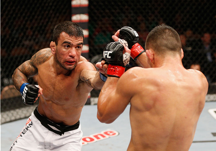 LAS VEGAS, NV - JULY 06:  (L-R) Leandro Issa punches Jumabieke Tuerxun in their bantamweight fight during the Ultimate Fighter Finale inside the Mandalay Bay Events Center on July 6, 2014 in Las Vegas, Nevada.  (Photo by Josh Hedges/Zuffa LLC/Zuffa LLC vi