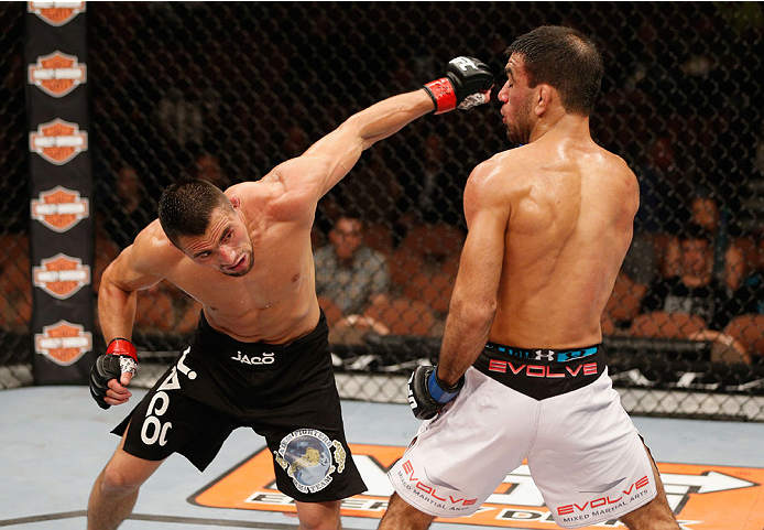 LAS VEGAS, NV - JULY 06:  (L-R) Jumabieke Tuerxun punches Leandro Issa in their bantamweight fight during the Ultimate Fighter Finale inside the Mandalay Bay Events Center on July 6, 2014 in Las Vegas, Nevada.  (Photo by Josh Hedges/Zuffa LLC/Zuffa LLC vi