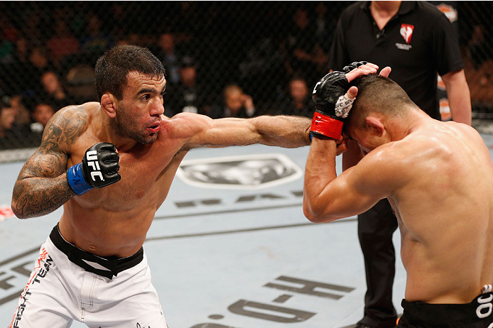LAS VEGAS, NV - JULY 06: (R-L) Jumabieke Tuerxun and Leandro Issa exchange punches in their bantamweight fight during the Ultimate Fighter Finale inside the Mandalay Bay Events Center on July 6, 2014 in Las Vegas, Nevada. (Photo by Josh Hedges/Zuffa LLC