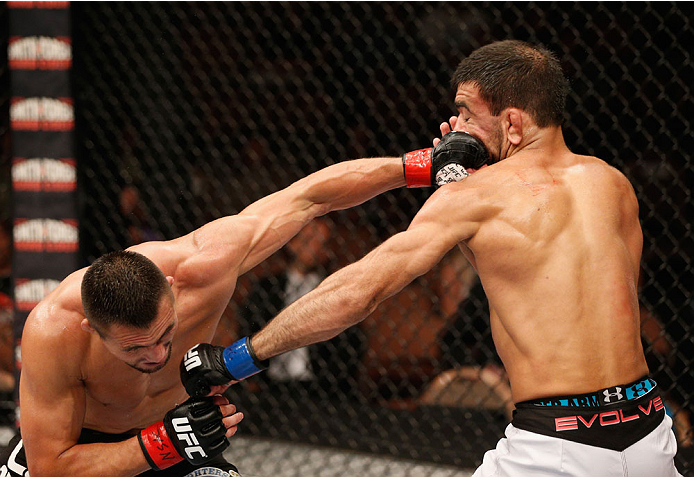 LAS VEGAS, NV - JULY 06:  (L-R) Jumabieke Tuerxun and Leandro Issa exchange punches in their bantamweight fight during the Ultimate Fighter Finale inside the Mandalay Bay Events Center on July 6, 2014 in Las Vegas, Nevada.  (Photo by Josh Hedges/Zuffa LLC