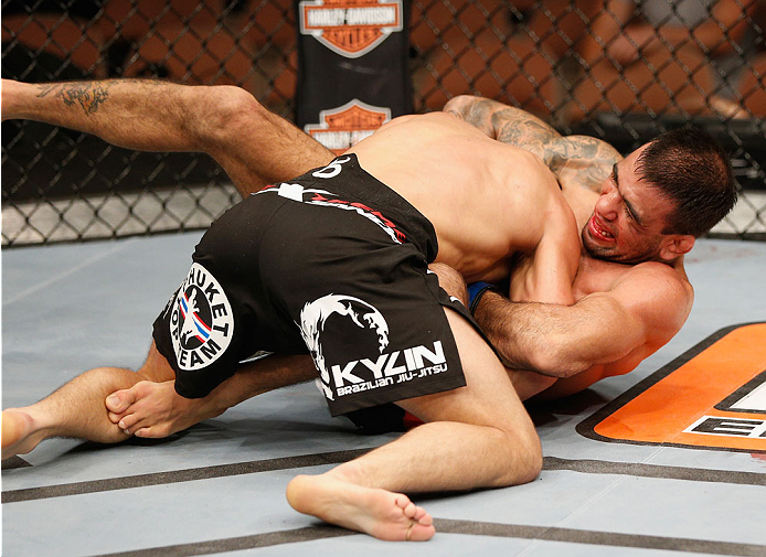 LAS VEGAS, NV - JULY 06:  Leandro Issa (bottom) attempts to submit Jumabieke Tuerxun in their bantamweight fight during the Ultimate Fighter Finale inside the Mandalay Bay Events Center on July 6, 2014 in Las Vegas, Nevada.  (Photo by Josh Hedges/Zuffa LL