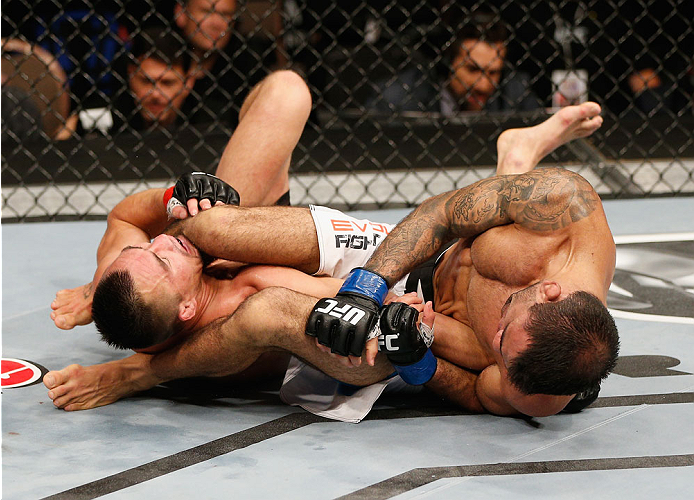 LAS VEGAS, NV - JULY 06: (R-L) Leandro Issa submits Jumabieke via armbar in their bantamweight fight during the Ultimate Fighter Finale inside the Mandalay Bay Events Center on July 6, 2014 in Las Vegas, Nevada. (Photo by Josh Hedges/Zuffa LLC/Zuffa LLC