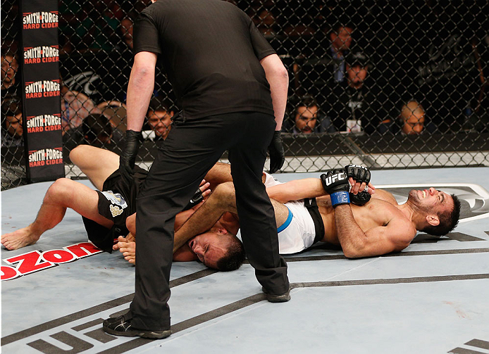 LAS VEGAS, NV - JULY 06:  (R-L) Leandro Issa submits Jumabieke via armbar in their bantamweight fight during the Ultimate Fighter Finale inside the Mandalay Bay Events Center on July 6, 2014 in Las Vegas, Nevada.  (Photo by Josh Hedges/Zuffa LLC/Zuffa LLC