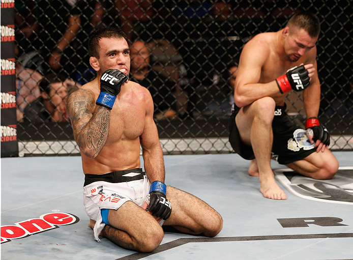 LAS VEGAS, NV - JULY 06:  (L) Leandro Issa celebrates after submitting Jumabieke Tuerxun in their bantamweight fight during the Ultimate Fighter Finale inside the Mandalay Bay Events Center on July 6, 2014 in Las Vegas, Nevada.  (Photo by Josh Hedges/Zuff