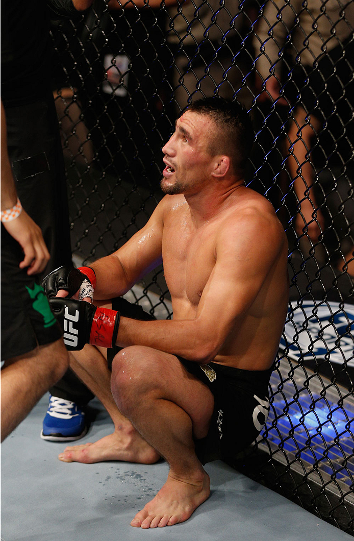 LAS VEGAS, NV - JULY 06:  Jumabieke Tuerxun recovers after being submitted by Leandro Issa in their bantamweight fight during the Ultimate Fighter Finale inside the Mandalay Bay Events Center on July 6, 2014 in Las Vegas, Nevada.  (Photo by Josh Hedges/Zu