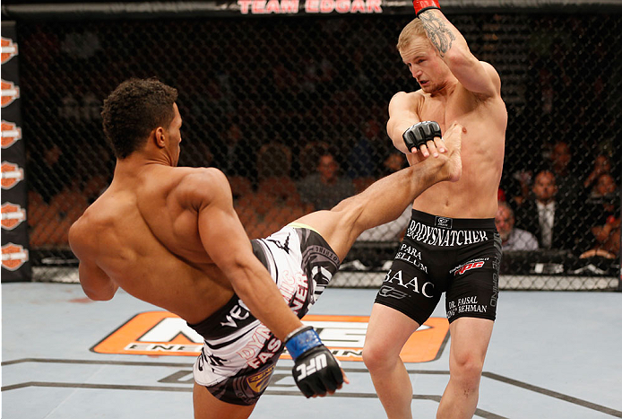 LAS VEGAS, NV - JULY 06:  (L-R) Kevin Lee kicks Jesse Ronson in their flyweight fight during the Ultimate Fighter Finale inside the Mandalay Bay Events Center on July 6, 2014 in Las Vegas, Nevada.  (Photo by Josh Hedges/Zuffa LLC/Zuffa LLC via Getty Image