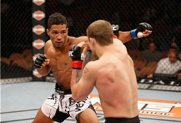 LAS VEGAS, NV - JULY 06: (L-R) Kevin Lee punches Jesse Ronson in their flyweight fight during the Ultimate Fighter Finale inside the Mandalay Bay Events Center on July 6, 2014 in Las Vegas, Nevada. (Photo by Josh Hedges/Zuffa LLC/Zuffa LLC via Getty Ima