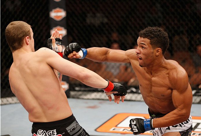 LAS VEGAS, NV - JULY 06: (R-L) Kevin Lee punches Jesse Ronson in their flyweight fight during the Ultimate Fighter Finale inside the Mandalay Bay Events Center on July 6, 2014 in Las Vegas, Nevada. (Photo by Josh Hedges/Zuffa LLC/Zuffa LLC via Getty Ima