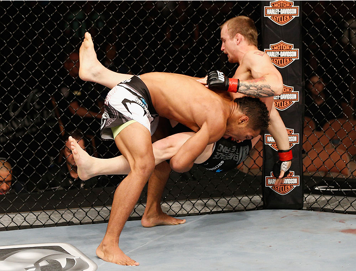 LAS VEGAS, NV - JULY 06:  Kevin Lee (bottom) takes down Jesse Ronson in their flyweight fight during the Ultimate Fighter Finale inside the Mandalay Bay Events Center on July 6, 2014 in Las Vegas, Nevada.  (Photo by Josh Hedges/Zuffa LLC/Zuffa LLC via Get