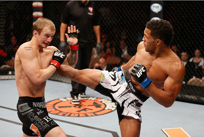 LAS VEGAS, NV - JULY 06: (R-L) Kevin Lee kicks Jesse Ronson in their flyweight fight during the Ultimate Fighter Finale inside the Mandalay Bay Events Center on July 6, 2014 in Las Vegas, Nevada. (Photo by Josh Hedges/Zuffa LLC/Zuffa LLC via Getty Image