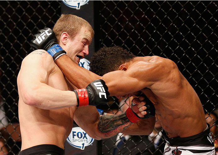 LAS VEGAS, NV - JULY 06: (L-R) Jesse Ronson punches Kevin Lee in their flyweight fight during the Ultimate Fighter Finale inside the Mandalay Bay Events Center on July 6, 2014 in Las Vegas, Nevada. (Photo by Josh Hedges/Zuffa LLC/Zuffa LLC via Getty Ima