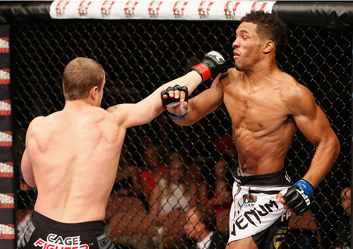 LAS VEGAS, NV - JULY 06: (L-R) Jesse Ronson punches Kevin Lee in their flyweight fight during the Ultimate Fighter Finale inside the Mandalay Bay Events Center on July 6, 2014 in Las Vegas, Nevada. (Photo by Josh Hedges/Zuffa LLC/Zuffa LLC via Getty Ima