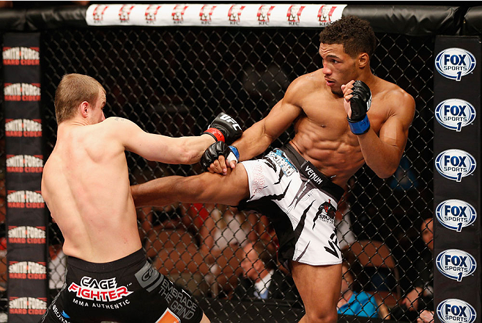 LAS VEGAS, NV - JULY 06: (R-L) Kevin Lee kicks Jesse Ronson in their flyweight fight during the Ultimate Fighter Finale inside the Mandalay Bay Events Center on July 6, 2014 in Las Vegas, Nevada. (Photo by Josh Hedges/Zuffa LLC/Zuffa LLC via Getty Image