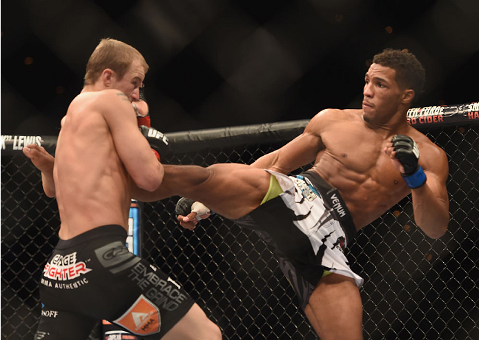 LAS VEGAS, NV - JULY 06: (R-L) Kevin Lee kicks Jesse Ronson in their flyweight fight during the Ultimate Fighter Finale inside the Mandalay Bay Events Center on July 6, 2014 in Las Vegas, Nevada. (Photo by Jeff Bottari/Zuffa LLC/Zuffa LLC via Getty Imag