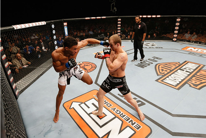 LAS VEGAS, NV - JULY 06: (L-R) Kevin Lee punches Jesse Ronson in their flyweight fight during the Ultimate Fighter Finale inside the Mandalay Bay Events Center on July 6, 2014 in Las Vegas, Nevada. (Photo by Josh Hedges/Zuffa LLC/Zuffa LLC via Getty Ima