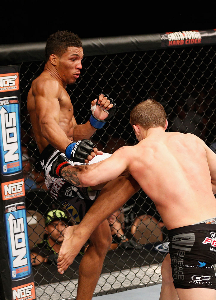 LAS VEGAS, NV - JULY 06: (L-R) Kevin Lee knees Jesse Ronson in their flyweight fight during the Ultimate Fighter Finale inside the Mandalay Bay Events Center on July 6, 2014 in Las Vegas, Nevada. (Photo by Josh Hedges/Zuffa LLC/Zuffa LLC via Getty Image