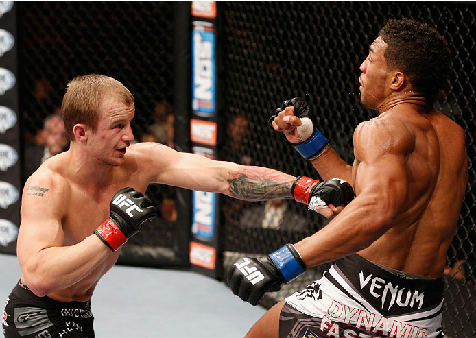LAS VEGAS, NV - JULY 06: (L-R) Jesse Ronson punches Kevin Lee in their flyweight fight during the Ultimate Fighter Finale inside the Mandalay Bay Events Center on July 6, 2014 in Las Vegas, Nevada. (Photo by Josh Hedges/Zuffa LLC/Zuffa LLC via Getty Ima