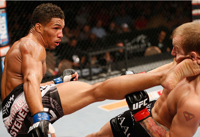 LAS VEGAS, NV - JULY 06:  (L-R) Kevin Lee kicks Jesse Ronson in their flyweight fight during the Ultimate Fighter Finale inside the Mandalay Bay Events Center on July 6, 2014 in Las Vegas, Nevada.  (Photo by Josh Hedges/Zuffa LLC/Zuffa LLC via Getty Image