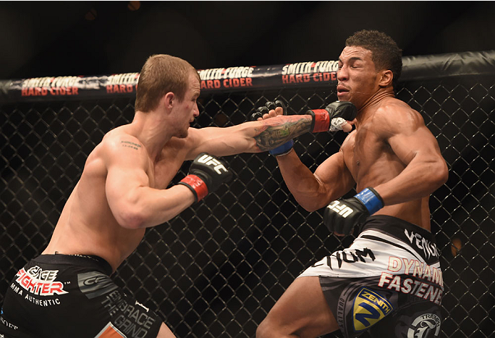 LAS VEGAS, NV - JULY 06: (L-R) Jesse Ronson punches Kevin Lee in their flyweight fight during the Ultimate Fighter Finale inside the Mandalay Bay Events Center on July 6, 2014 in Las Vegas, Nevada. (Photo by Jeff Bottari/Zuffa LLC/Zuffa LLC via Getty Im