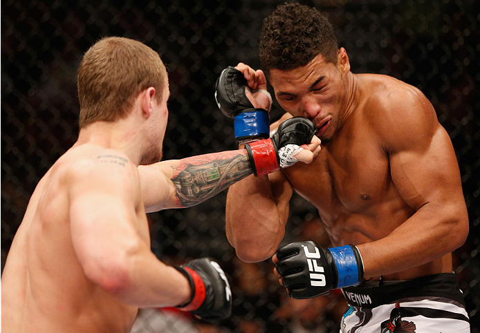 LAS VEGAS, NV - JULY 06: (L-R) Jesse Ronson punches Kevin Lee in their flyweight fight during the Ultimate Fighter Finale inside the Mandalay Bay Events Center on July 6, 2014 in Las Vegas, Nevada. (Photo by Josh Hedges/Zuffa LLC/Zuffa LLC via Getty Ima