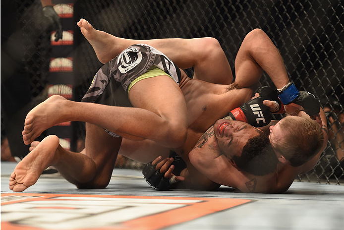 LAS VEGAS, NV - JULY 06: (R-L) Jesse Ronson attempts to submit Kevin Lee in their flyweight fight during the Ultimate Fighter Finale inside the Mandalay Bay Events Center on July 6, 2014 in Las Vegas, Nevada. (Photo by Jeff Bottari/Zuffa LLC/Zuffa LLC v