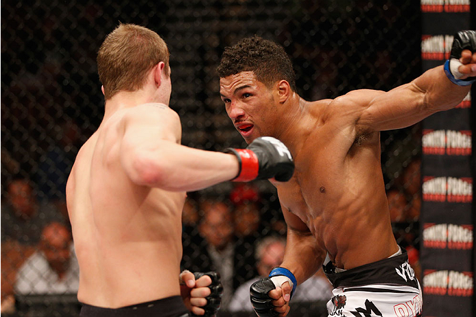 LAS VEGAS, NV - JULY 06: (R-L) Kevin Lee punches Jesse Ronson in their flyweight fight during the Ultimate Fighter Finale inside the Mandalay Bay Events Center on July 6, 2014 in Las Vegas, Nevada. (Photo by Josh Hedges/Zuffa LLC/Zuffa LLC via Getty Ima