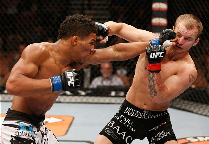 LAS VEGAS, NV - JULY 06:  (L-R) Kevin Lee punches Jesse Ronson in their flyweight fight during the Ultimate Fighter Finale inside the Mandalay Bay Events Center on July 6, 2014 in Las Vegas, Nevada.  (Photo by Josh Hedges/Zuffa LLC/Zuffa LLC via Getty Ima