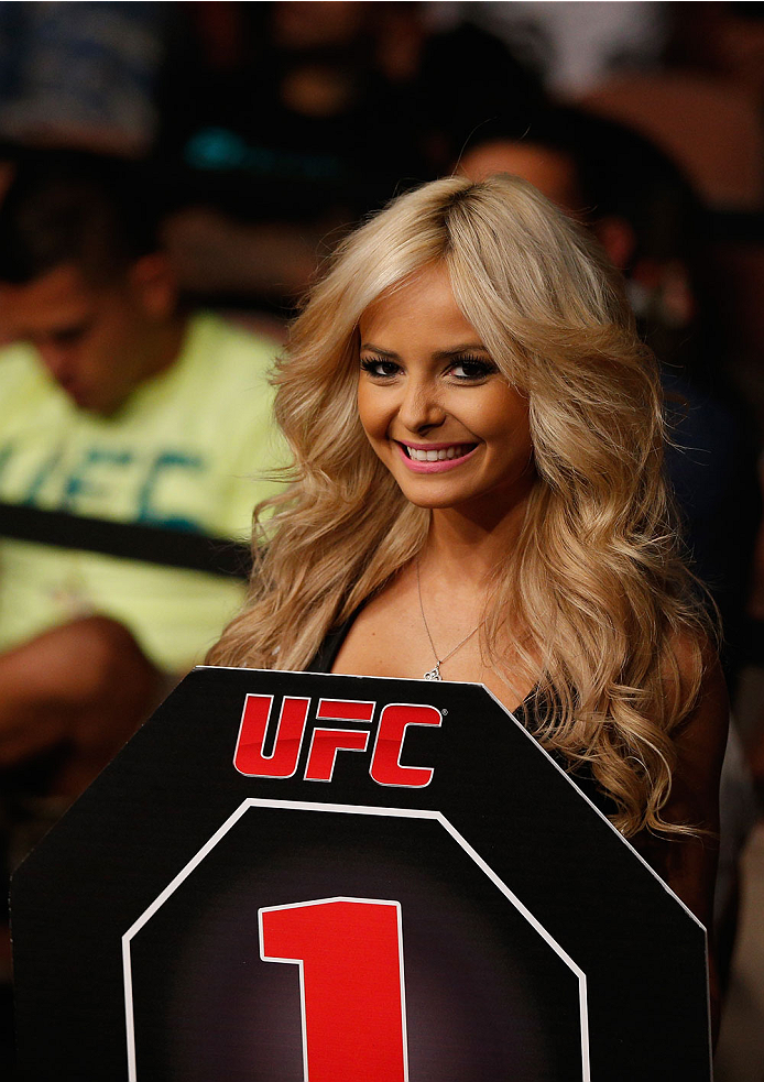 LAS VEGAS, NV - JULY 06:  UFC Octagon Girl Jhenny Adrade announces round one in their flyweight fight during the Ultimate Fighter Finale inside the Mandalay Bay Events Center on July 6, 2014 in Las Vegas, Nevada.  (Photo by Josh Hedges/Zuffa LLC/Zuffa LLC