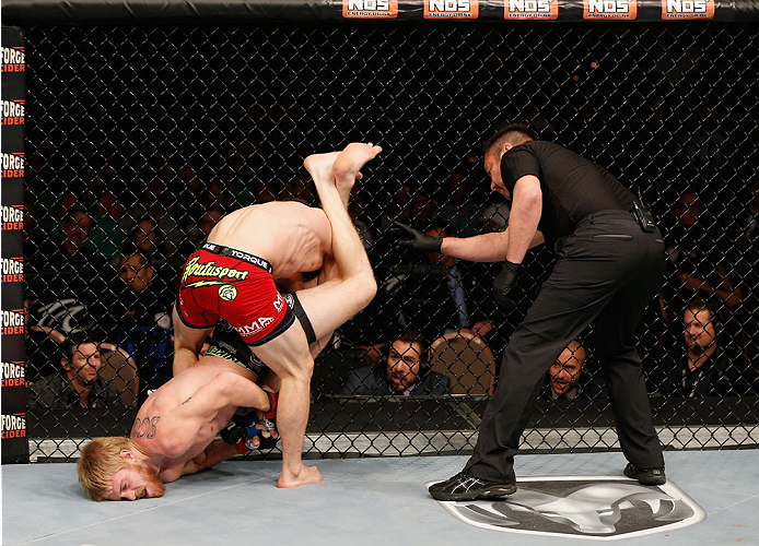LAS VEGAS, NV - JULY 06: Justin Scoggins (bottom) attempts an armbar on Dustin Ortiz in their flyweight fight during the Ultimate Fighter Finale inside the Mandalay Bay Events Center on July 6, 2014 in Las Vegas, Nevada. (Photo by Josh Hedges/Zuffa LLC/