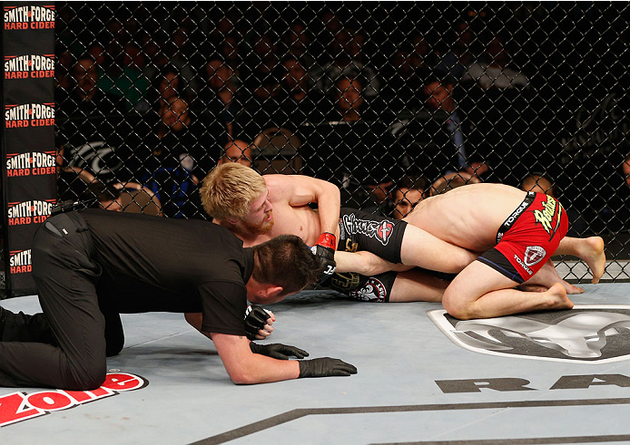 LAS VEGAS, NV - JULY 06: (L-R) Justin Scoggins attempts to armbar Dustin Ortiz in their flyweight fight during the Ultimate Fighter Finale inside the Mandalay Bay Events Center on July 6, 2014 in Las Vegas, Nevada. (Photo by Josh Hedges/Zuffa LLC/Zuffa