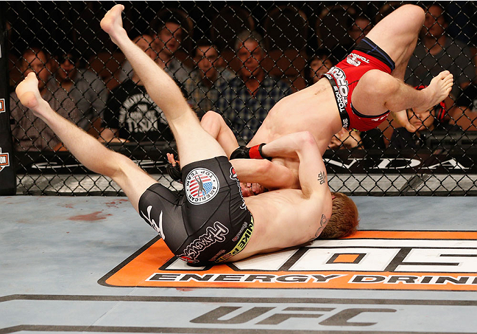 LAS VEGAS, NV - JULY 06: Justin Scoggins (bottom) grapples with Dustin Ortiz in their flyweight fight during the Ultimate Fighter Finale inside the Mandalay Bay Events Center on July 6, 2014 in Las Vegas, Nevada. (Photo by Josh Hedges/Zuffa LLC/Zuffa LL